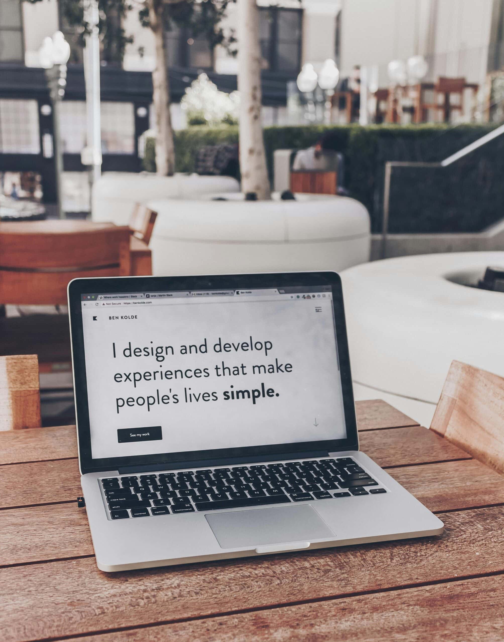 A laptop screen that says, "I design and develop experiences that make people's lives simpler."